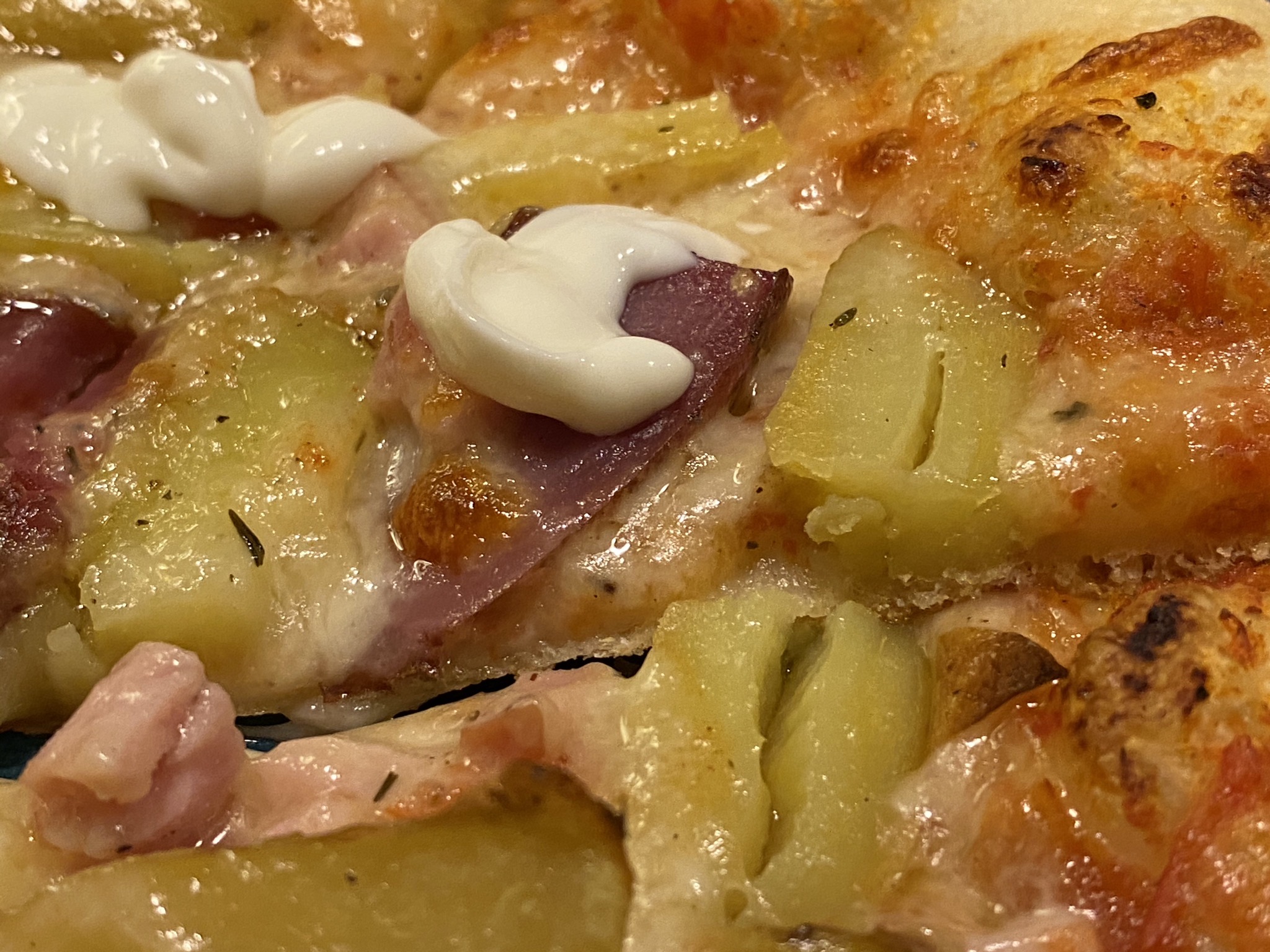 Pizza with roast potatoes, Canadian bacon, sour cream