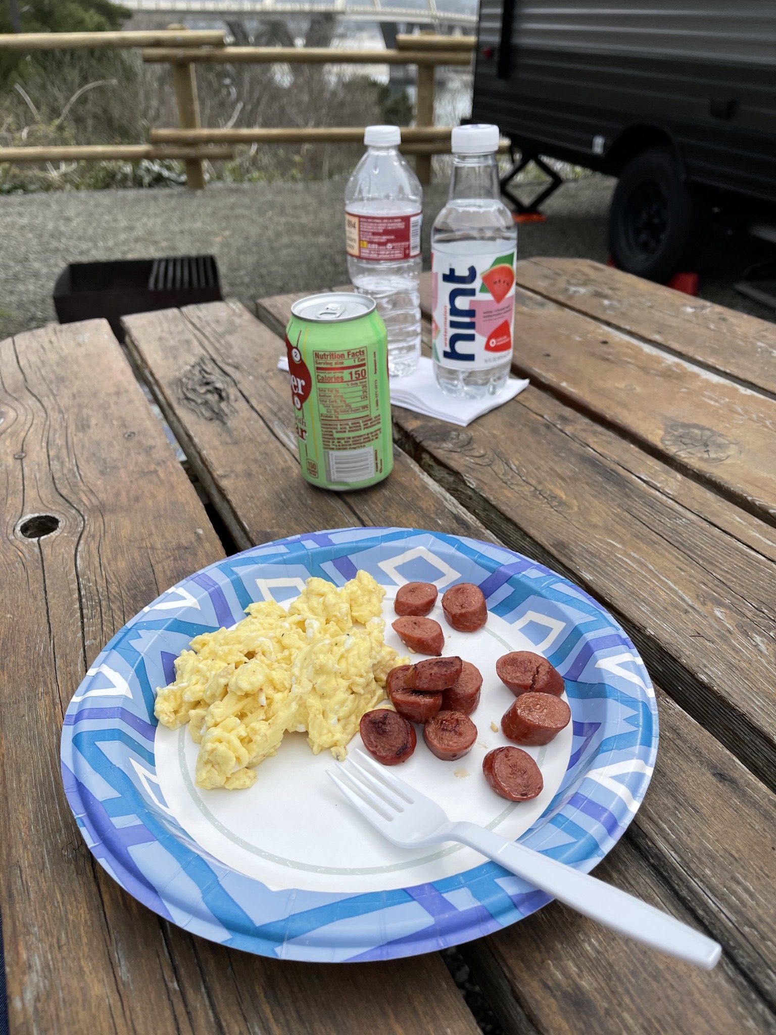 Scrambled eggs and sliced hot dog