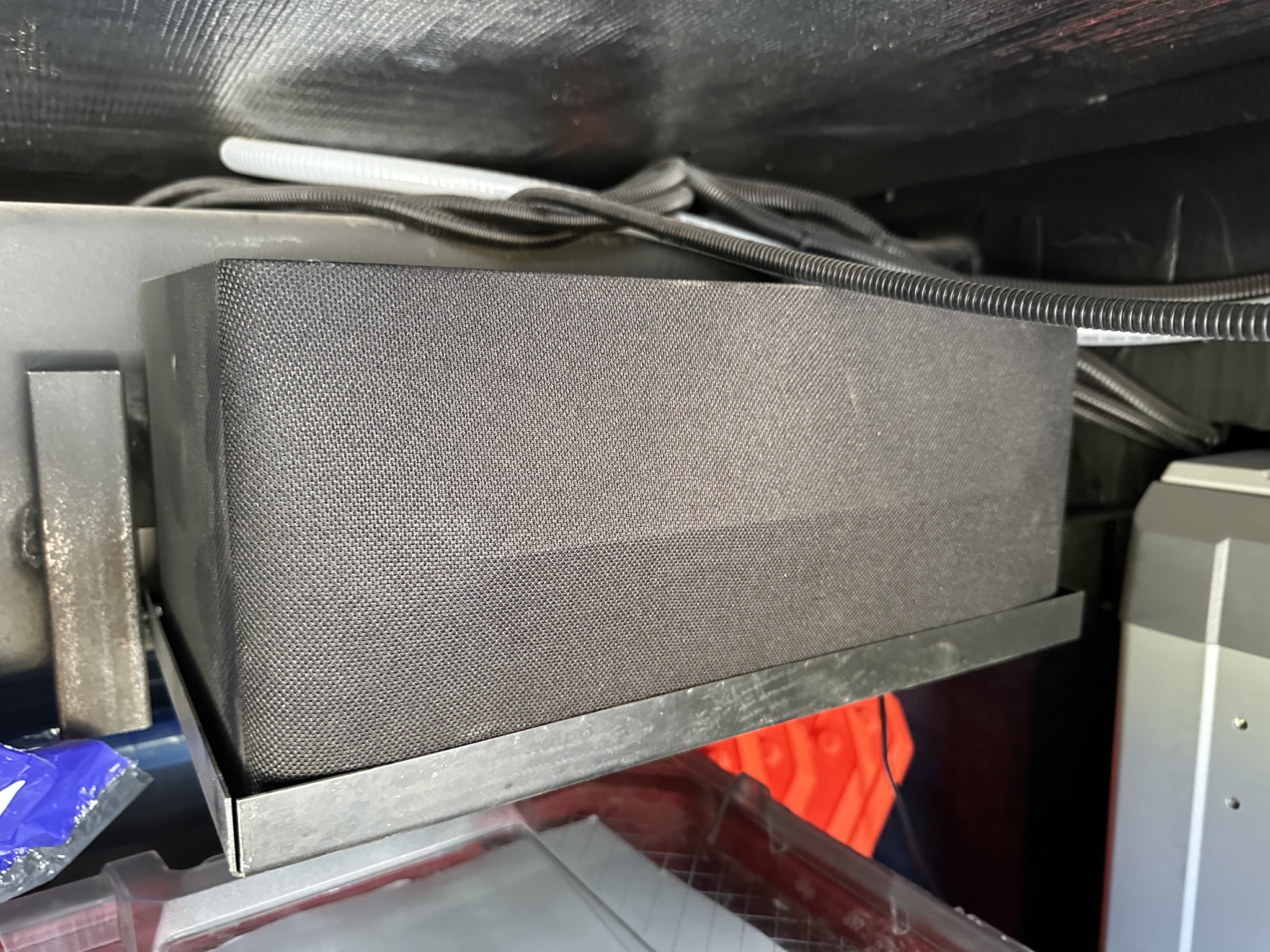 Subwoofer on a shelf in a basement compartment of my motorhome