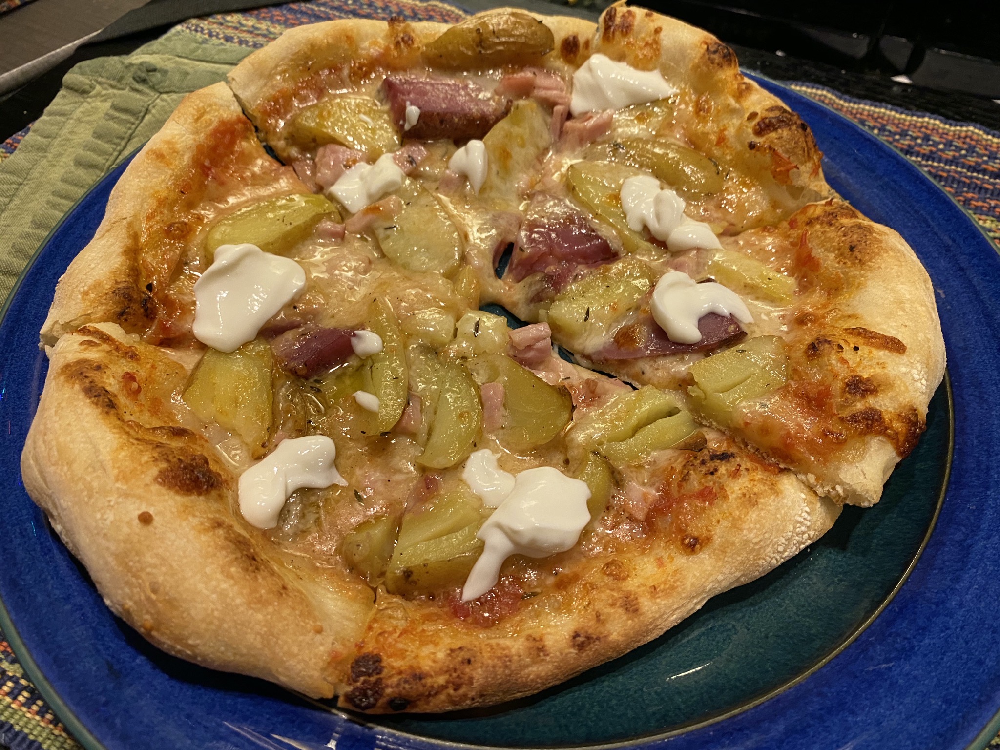 Pizza with roast potatoes, Canadian bacon, sour cream