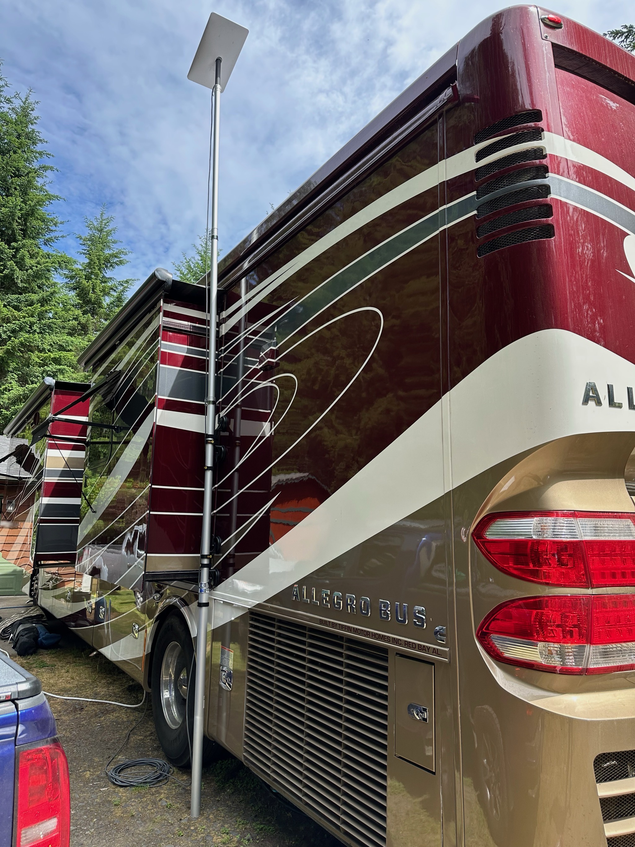 Flagpole with Starlink dish mounted on motorhome