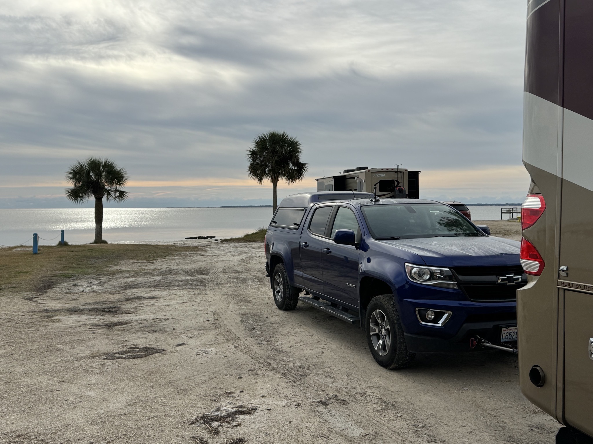Beach behind RV and truck