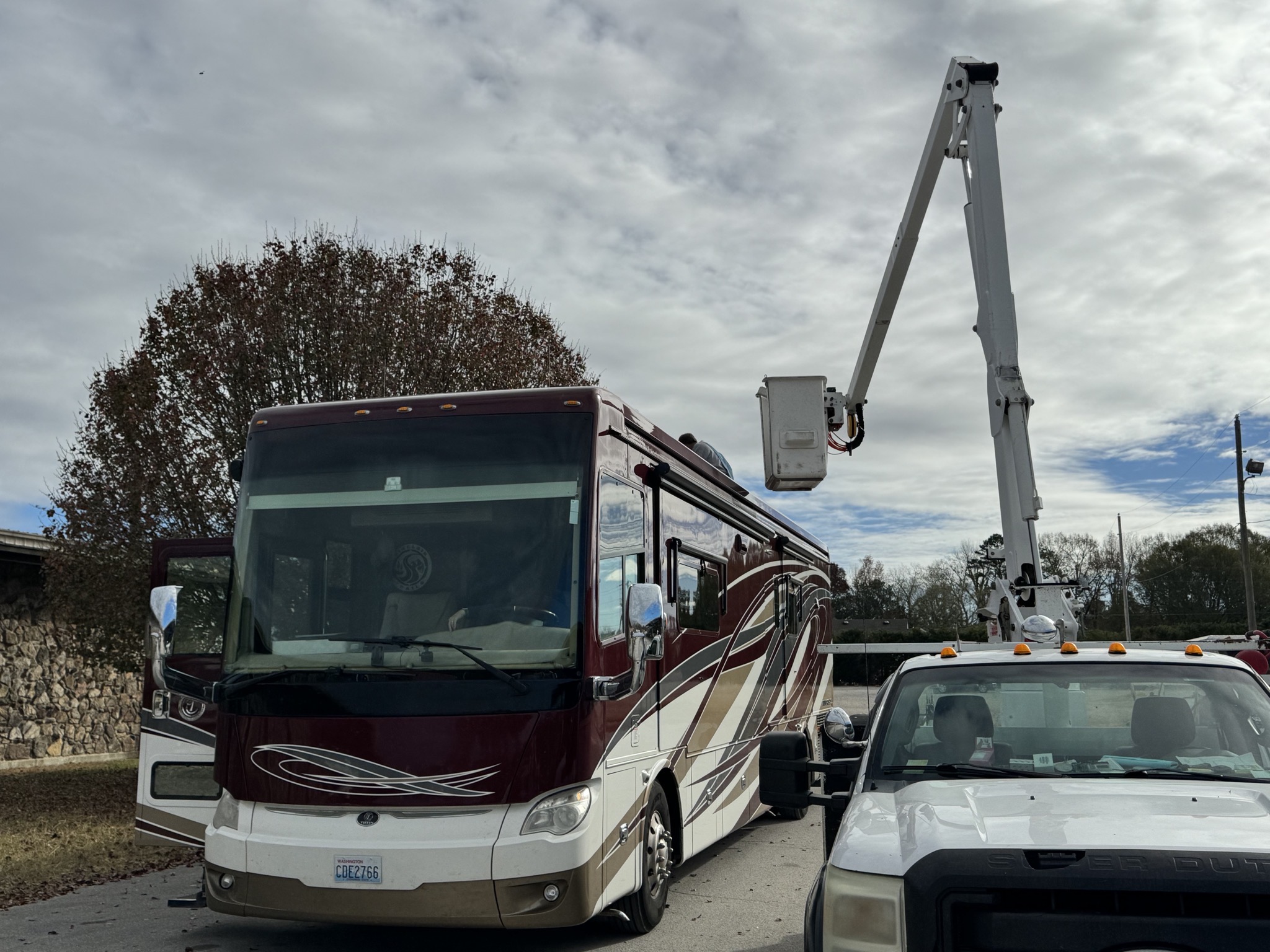 Motorhome with cherry picker truck