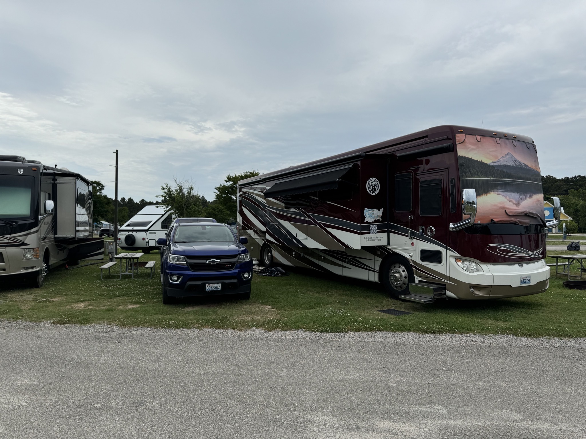 Truck and motorhome in a grassy campsite