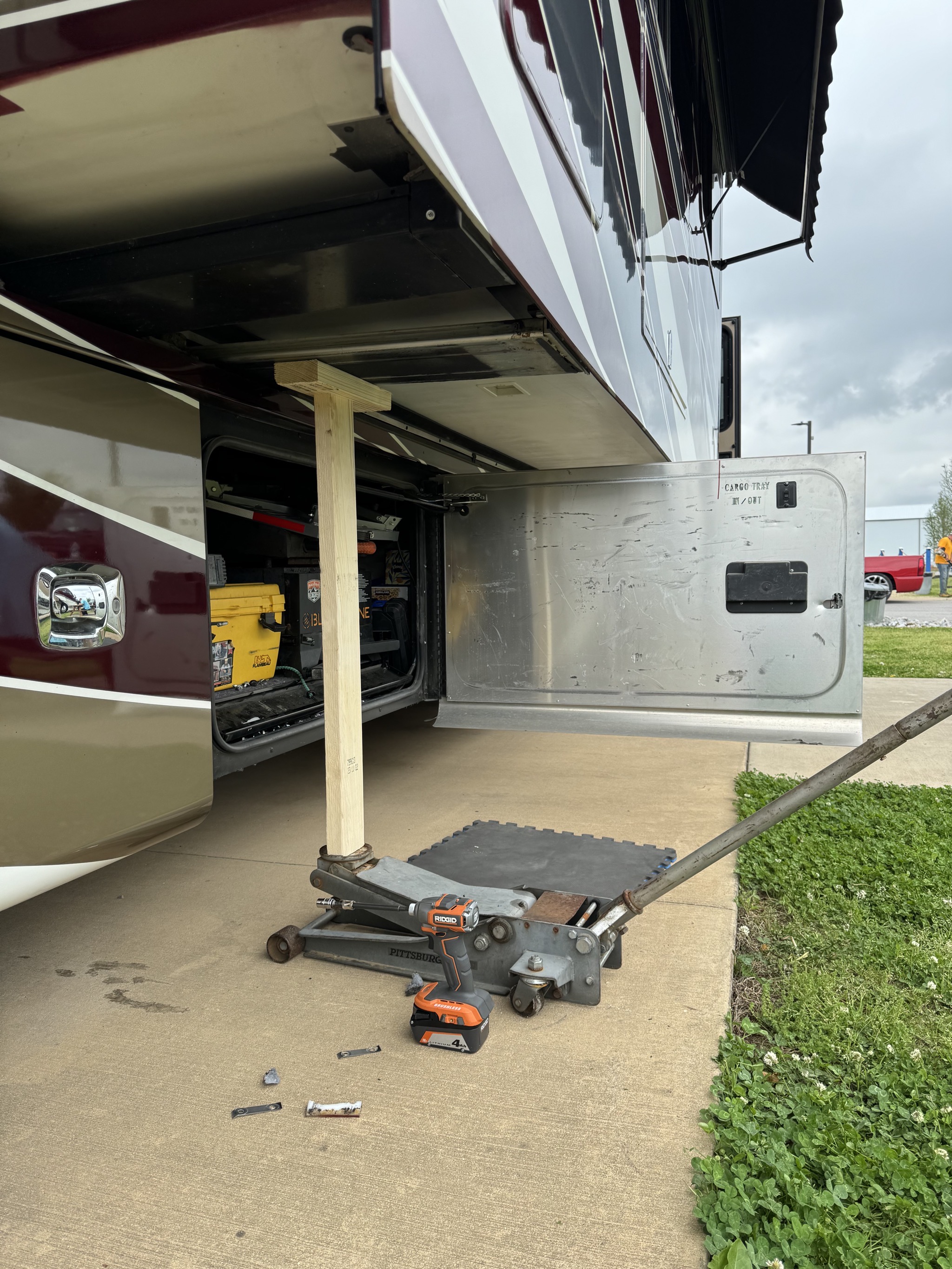 A jack raising up the RV slideout to replace the glide block