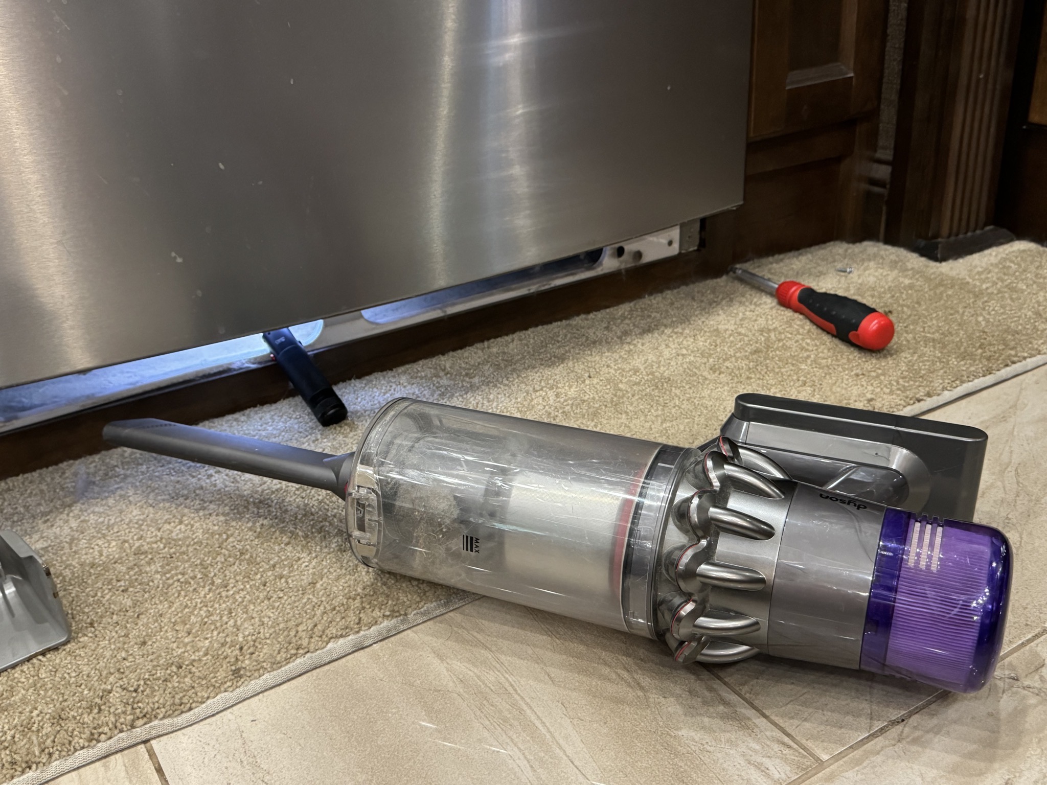 Vacuuming out under fridge
