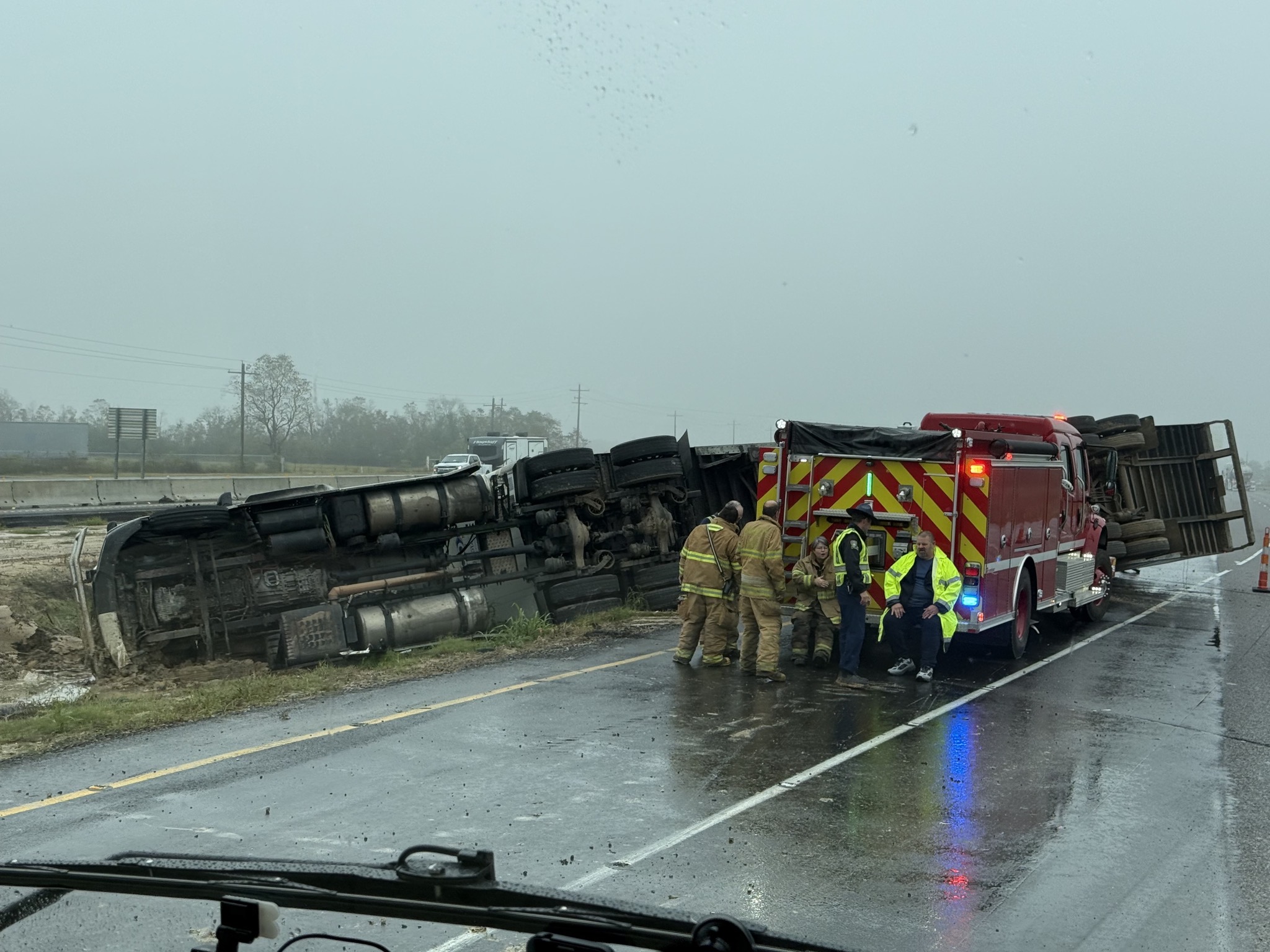 Truck on its side with fire truck